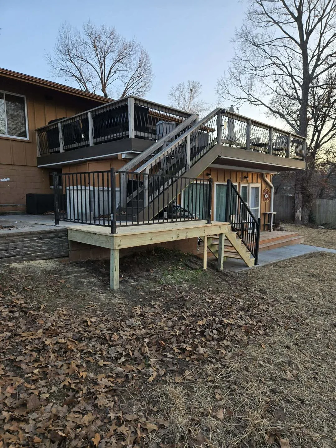 Multi-level composite deck with metal railing system
